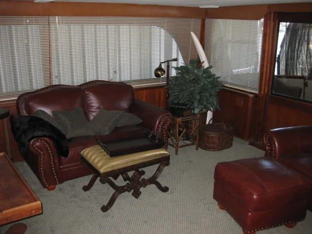 Slide: The Image of 1984 Chris-Craft Constellation interior with leather seating, wooden accents, and decorative plants. - 35