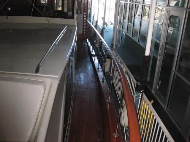 Slide: The Image of 1984 Chris-Craft Constellation yacht deck with wooden railings and sleek design. - 37
