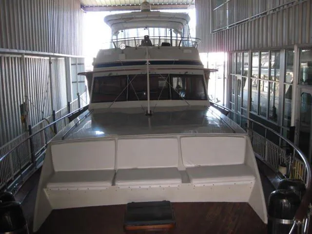 Slide: The Image of 1984 Chris-Craft Constellation yacht docked in a covered marina. - 41