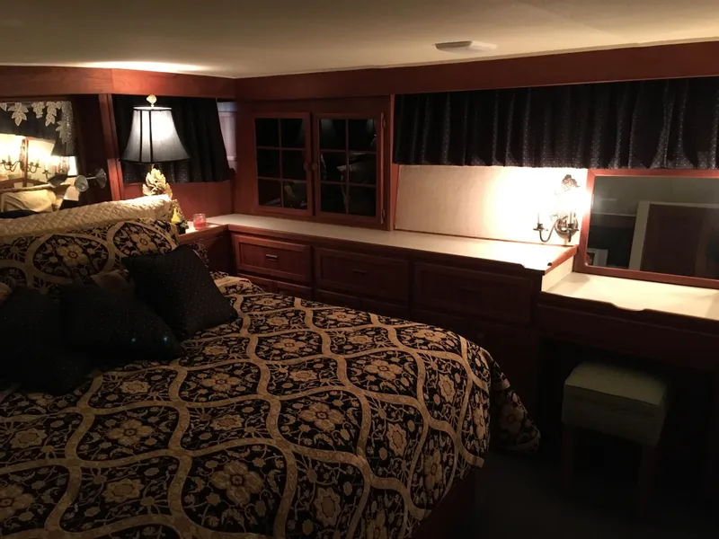Slide: The Image of Luxurious bedroom interior of 1984 Chris-Craft Constellation yacht with elegant bedding and warm lighting. - 49