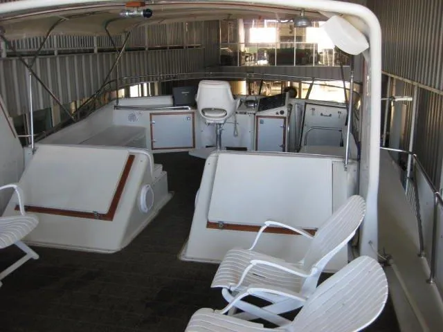 Slide: The Image of 1984 Chris-Craft Constellation boat interior with white seating and control panel. - 7