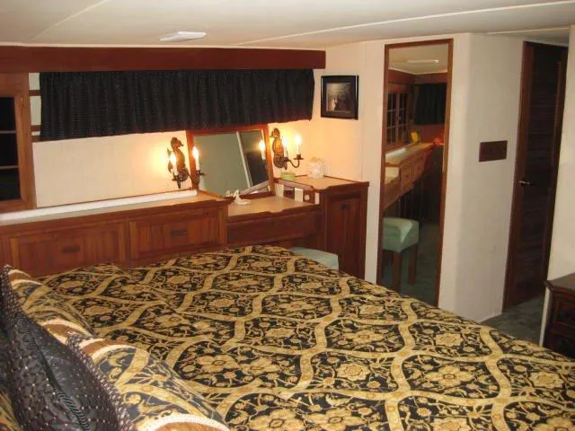 Slide: The Image of Luxurious bedroom interior of 1984 Chris-Craft Constellation yacht with elegant decor and lighting. - 9