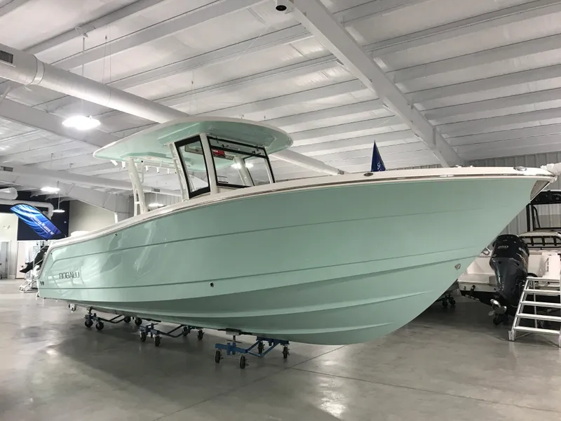 Slide: The Image of 2024 Robalo R302 boat in showroom, side view. - 1