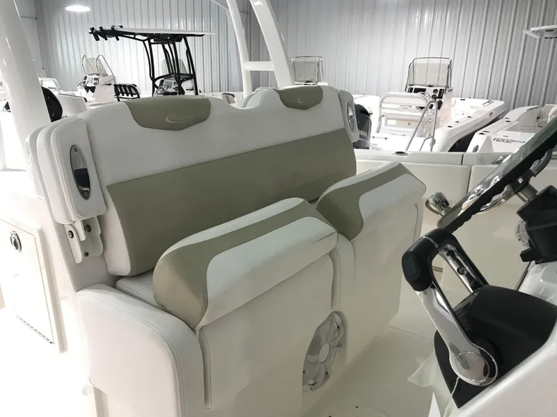 Slide: The Image of 2024 Robalo R302 boat interior seating and helm station. - 11