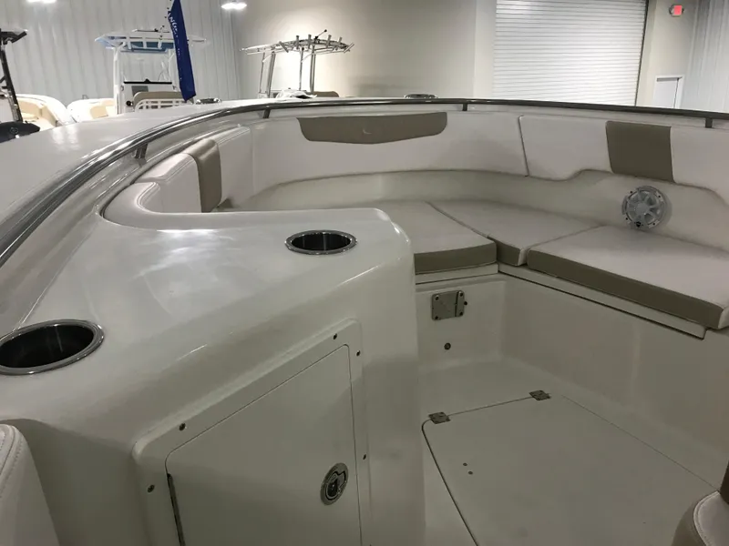 Slide: The Image of 2024 Robalo R302 boat interior with cushioned seating and cup holders. - 18