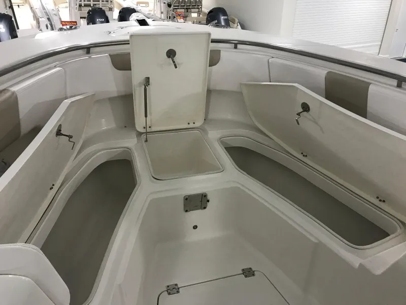 Slide: The Image of 2024 Robalo R302 boat with open storage compartments. - 21