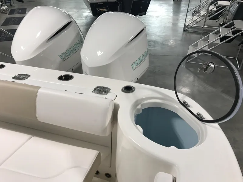 Slide: The Image of 2024 Robalo R302 boat with dual Yamaha engines and seating area. - 8