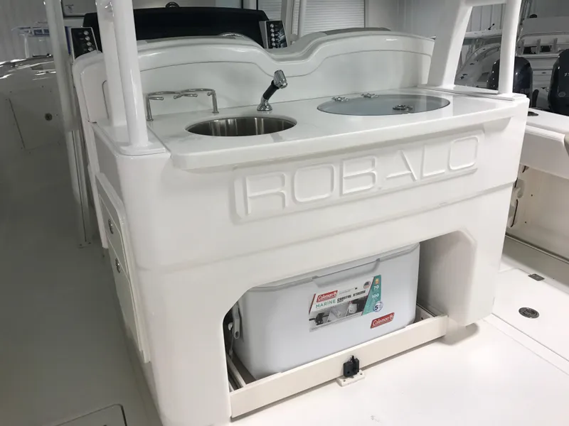 Slide: The Image of 2024 Robalo R302 boat interior with sink and storage compartment. - 9