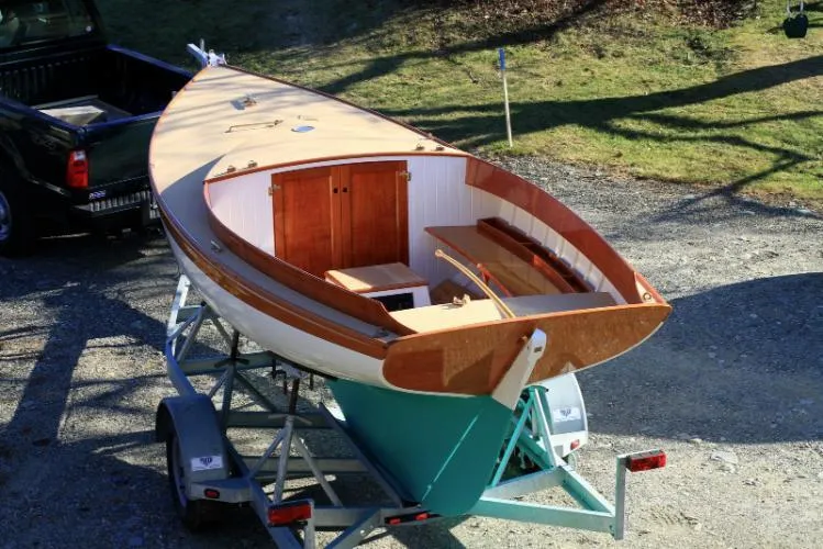 Slide: The Image of 2011 Herreshoff Fish Class sailboat on trailer, wooden deck, ready for transport. - 2