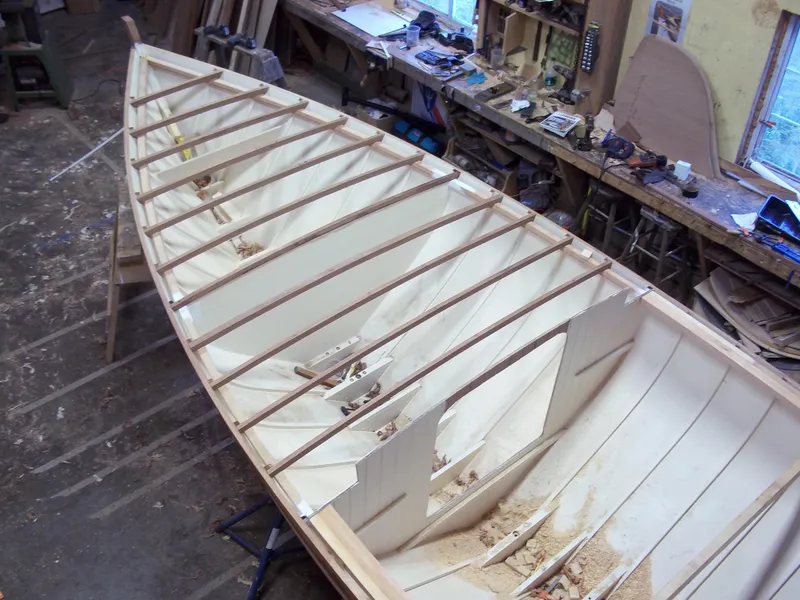 Slide: The Image of Herreshoff Fish Class 2011 boat under construction in a workshop setting. - 7
