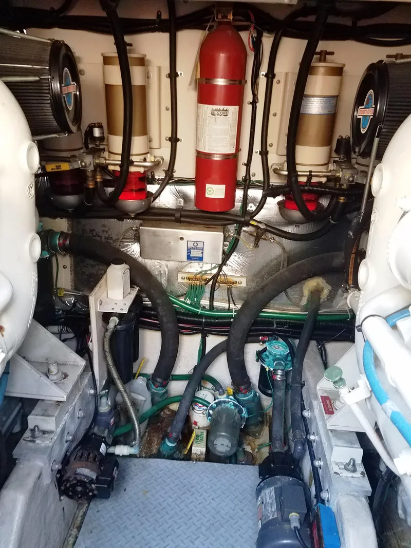 Slide: The Image of Engine room of a 1996 Sea Ray 500 Sundancer with visible machinery and fire extinguisher. - 22
