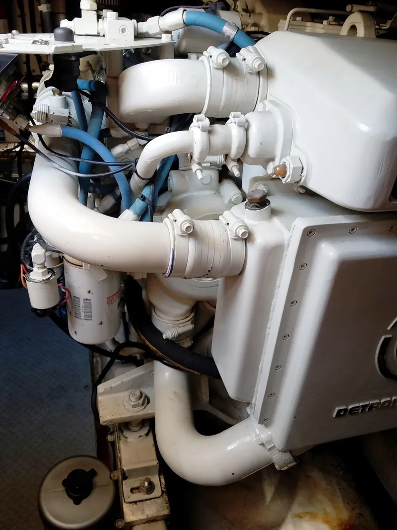 Slide: The Image of Engine compartment of a 1996 Sea Ray 500 Sundancer with visible pipes and components. - 23