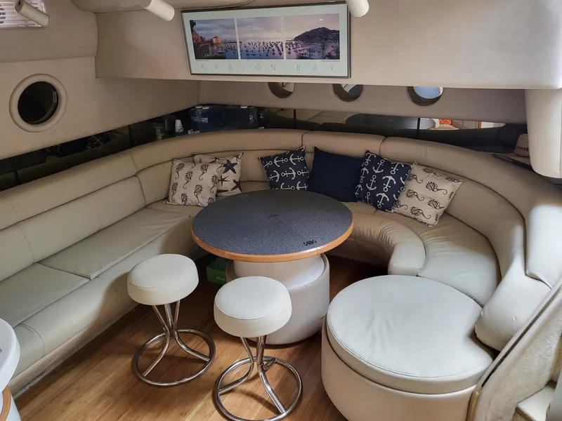 Slide: The Image of Interior of 1996 Sea Ray 500 Sundancer yacht with plush seating and nautical decor. - 25