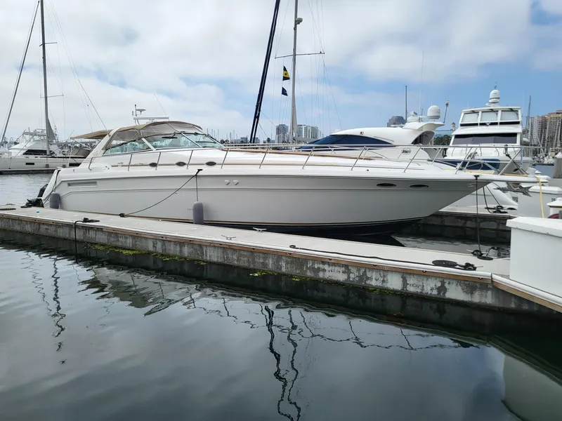 Slide: The Image of 1996 Sea Ray 500 Sundancer yacht docked in a marina, surrounded by other boats. - 26