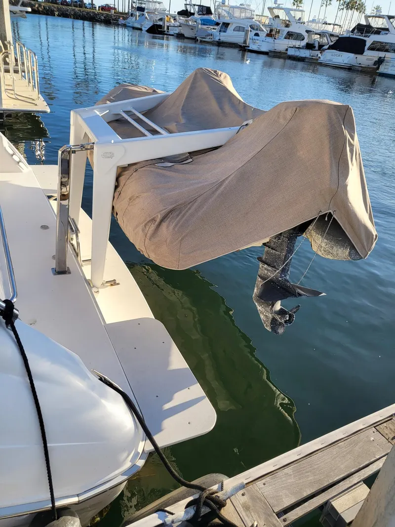 Slide: The Image of Covered outboard motor on a 1996 Sea Ray 500 Sundancer at a marina. - 3