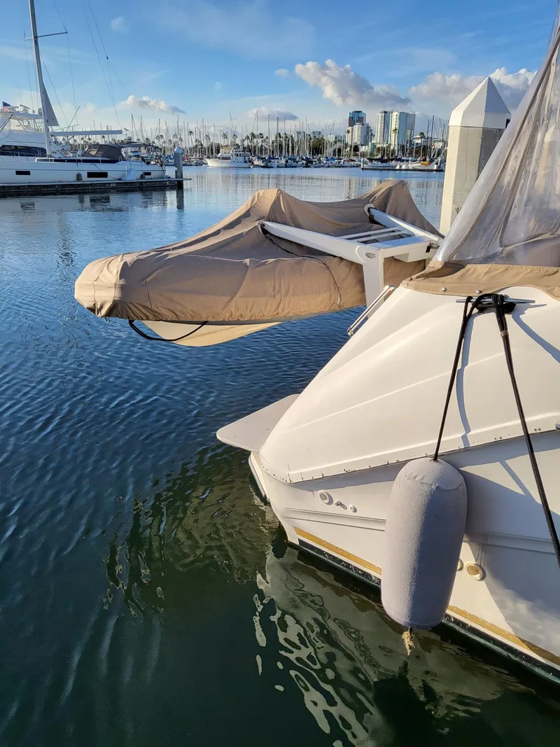 Slide: The Image of 1996 Sea Ray 500 Sundancer docked in a marina with city skyline. - 4