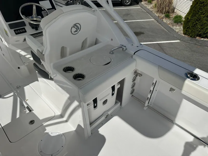 Slide: The Image of 2025 Edgewater 248CX Crossover boat interior with adjustable seating and storage compartment. - 15