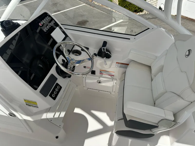 Slide: The Image of Open storage compartment on 2025 Edgewater 248CX Crossover boat. - 22