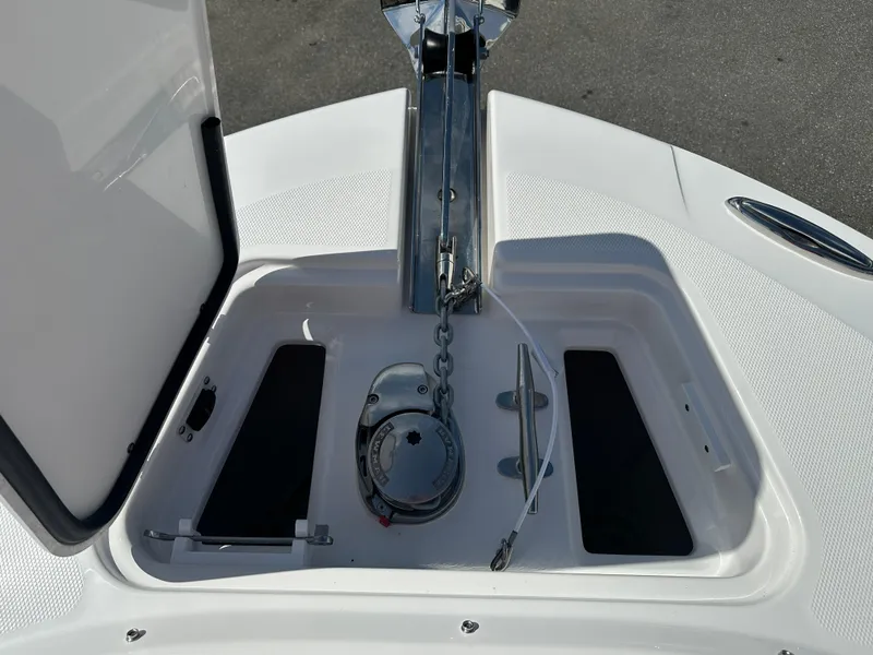 Slide: The Image of 2025 Edgewater 248CX Crossover boat bow with white seating and anchor. - 32