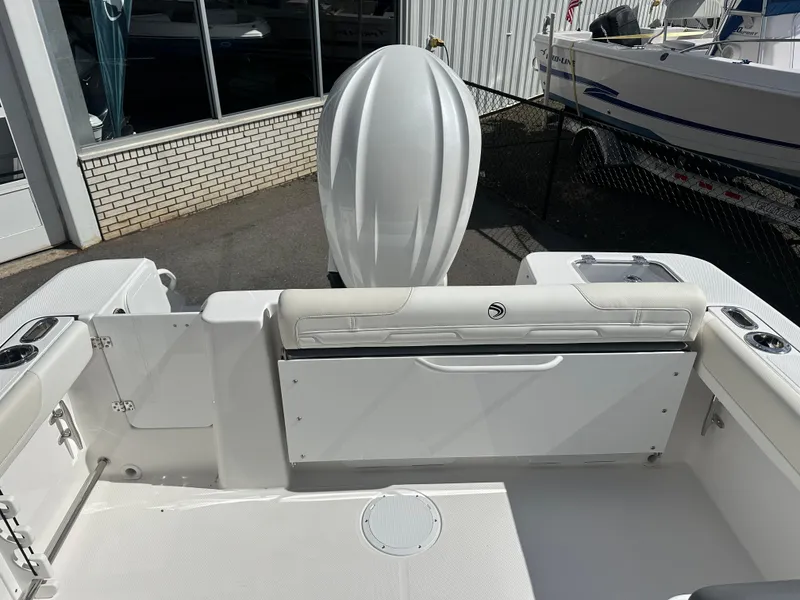 Slide: The Image of 2025 Edgewater 248CX Crossover boat with spacious seating and sleek design under a clear sky. - 9