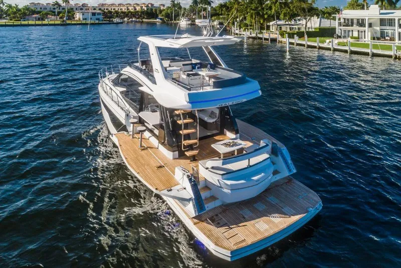 Slide: The Image of 2023 Galeon 500 Fly yacht cruising on a sunny waterfront. - 10
