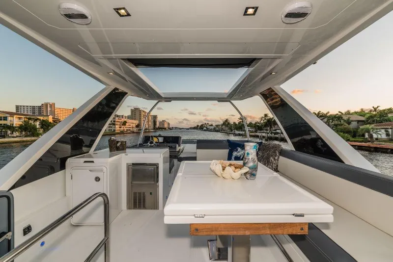 Slide: The Image of Interior of 2023 Galeon 500 Fly yacht with modern seating and dining area. - 17