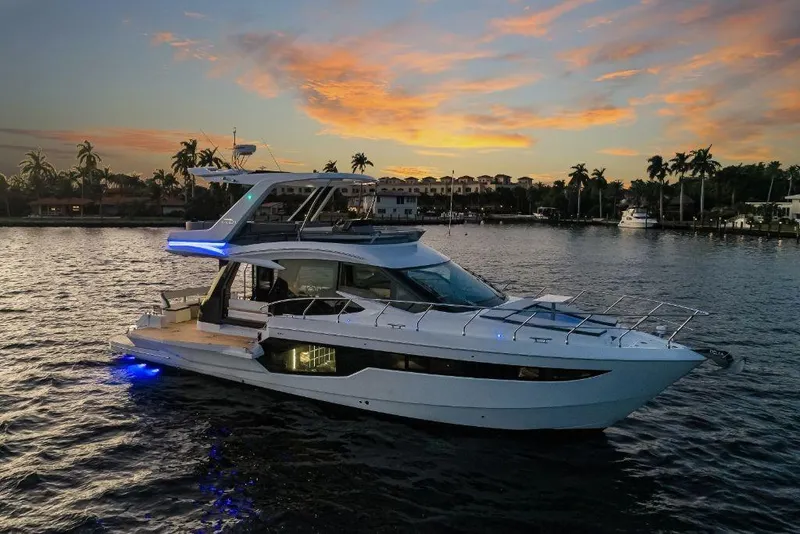 Slide: The Image of 2023 Galeon 500 Fly yacht at sunset on a serene waterway. - 3