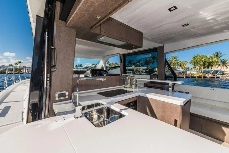 Slide: The Image of Modern kitchen area on the 2023 Galeon 500 Fly yacht with waterfront view. - 32