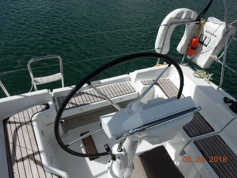 Slide: The Image of Cockpit of 2013 Jeanneau Sun Odyssey 33i sailboat with steering wheel and seating. - 15