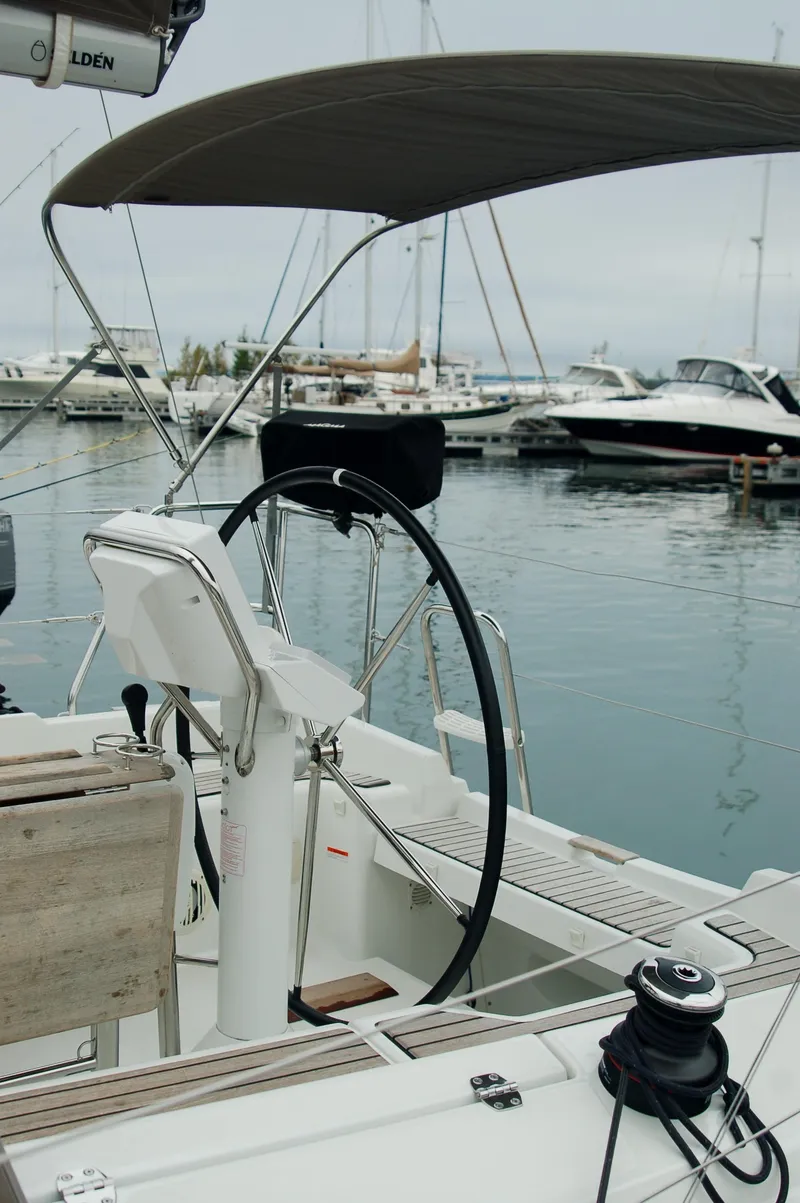 Slide: The Image of Jeanneau Sun Odyssey 33i sailboat cockpit, 2013 model, docked in marina. - 16