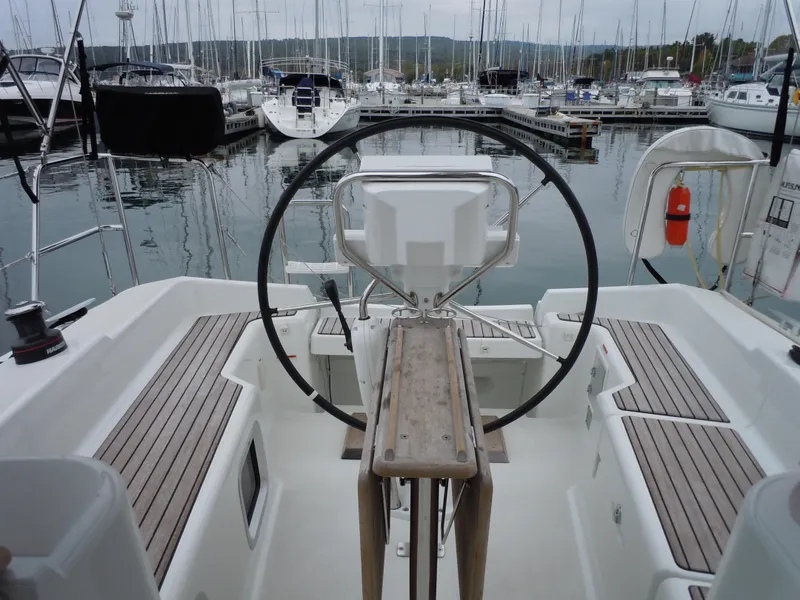 Slide: The Image of Cockpit of 2013 Jeanneau Sun Odyssey 33i sailboat in marina setting. - 17