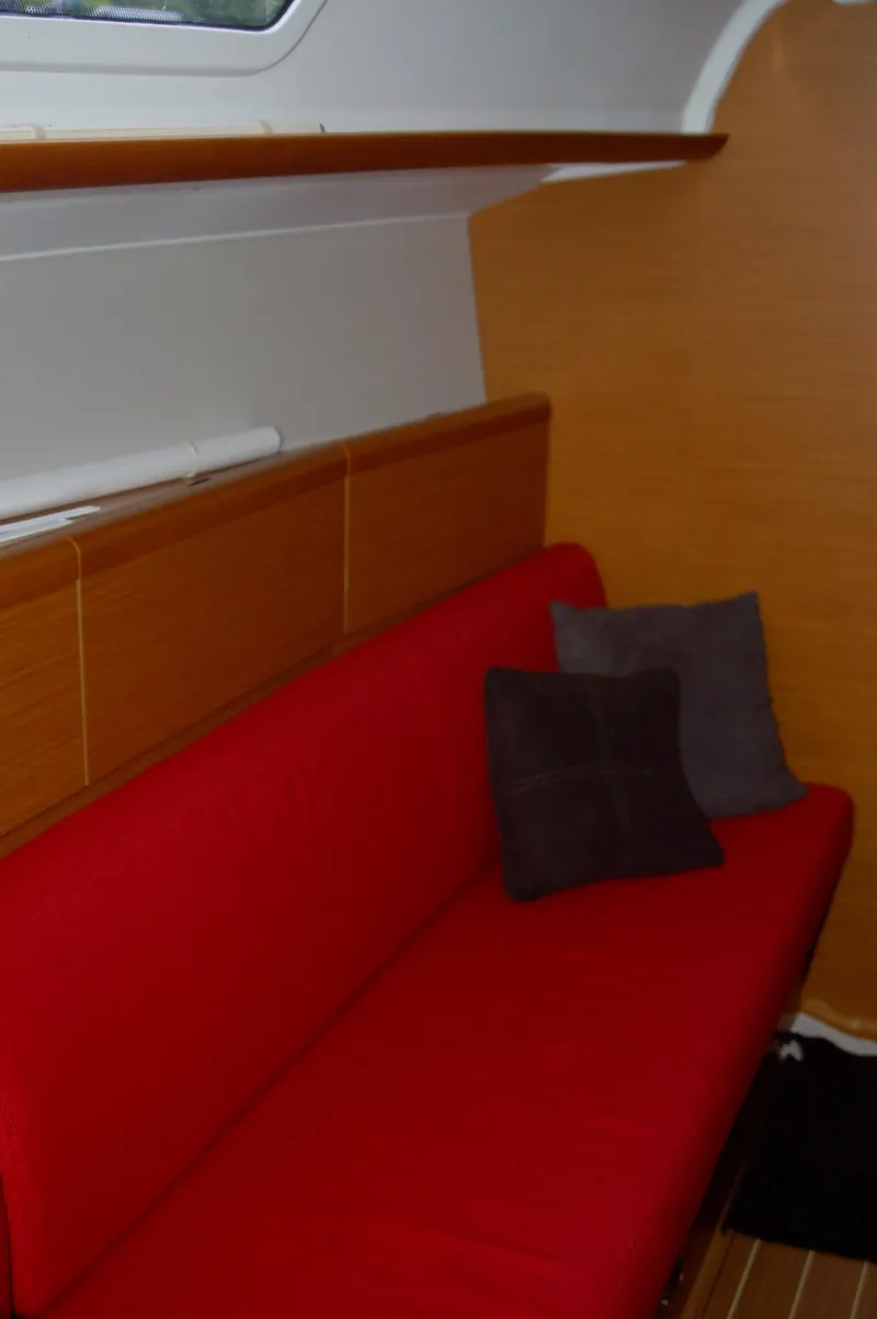Slide: The Image of Interior of 2013 Jeanneau Sun Odyssey 33i with red sofa and cushions. - 21