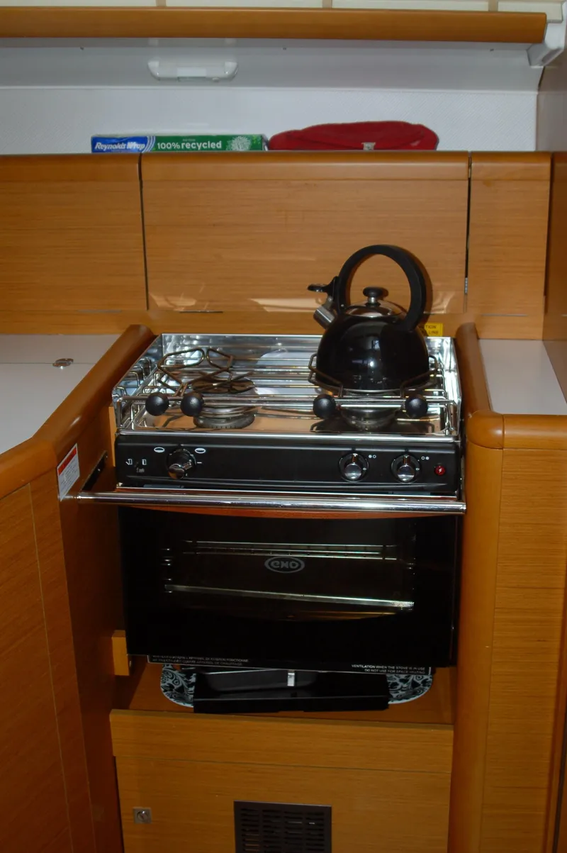 Slide: The Image of Compact kitchen in 2013 Jeanneau Sun Odyssey 33i yacht with stove and kettle. - 22