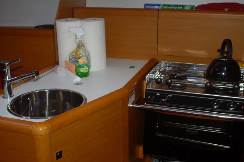 Slide: The Image of Compact kitchen area in a 2013 Jeanneau Sun Odyssey 33i sailboat. - 3
