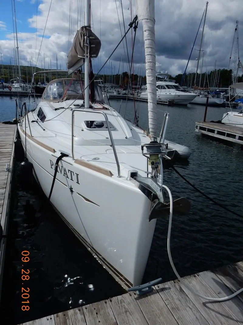 Slide: The Image of 2013 Jeanneau Sun Odyssey 33i sailboat docked at a marina. - 7