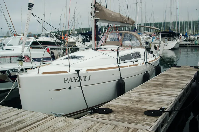 Slide: The Image of 2013 Jeanneau Sun Odyssey 33i sailboat docked in marina, named "Pavati". - 8