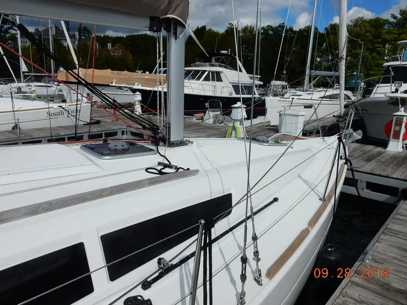 Slide: The Image of Sailboat Jeanneau Sun Odyssey 33i, 2013 model, docked at a marina. - 9