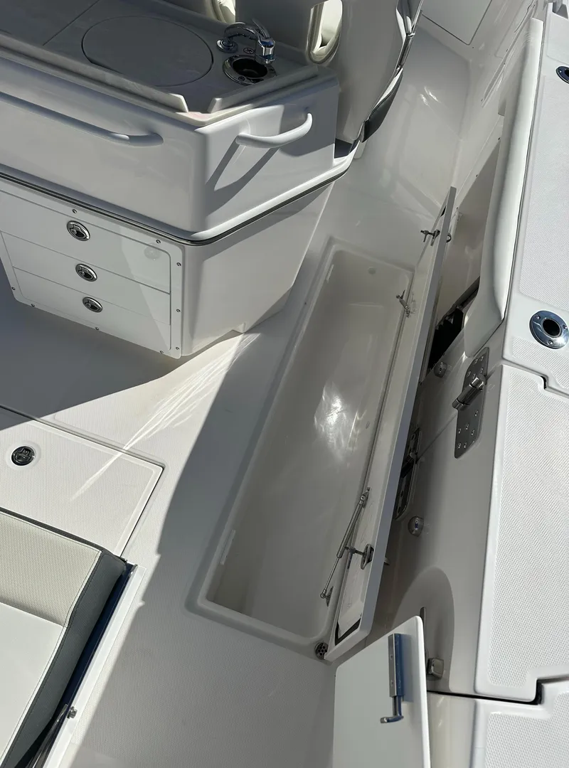 Slide: The Image of 2025 Edgewater 262 Center Console boat interior with open storage compartments. - 12
