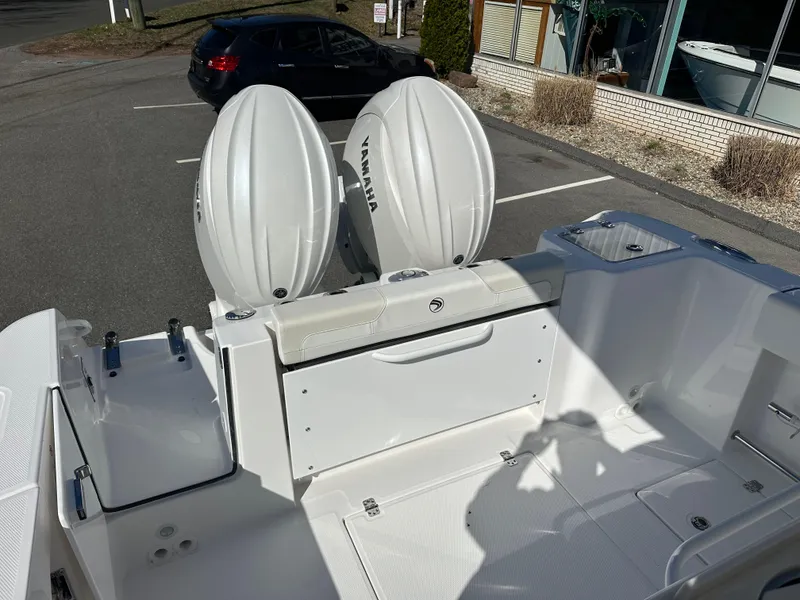 Slide: The Image of 2025 Edgewater 262 Center Console boat with twin Yamaha engines in a parking lot. - 14