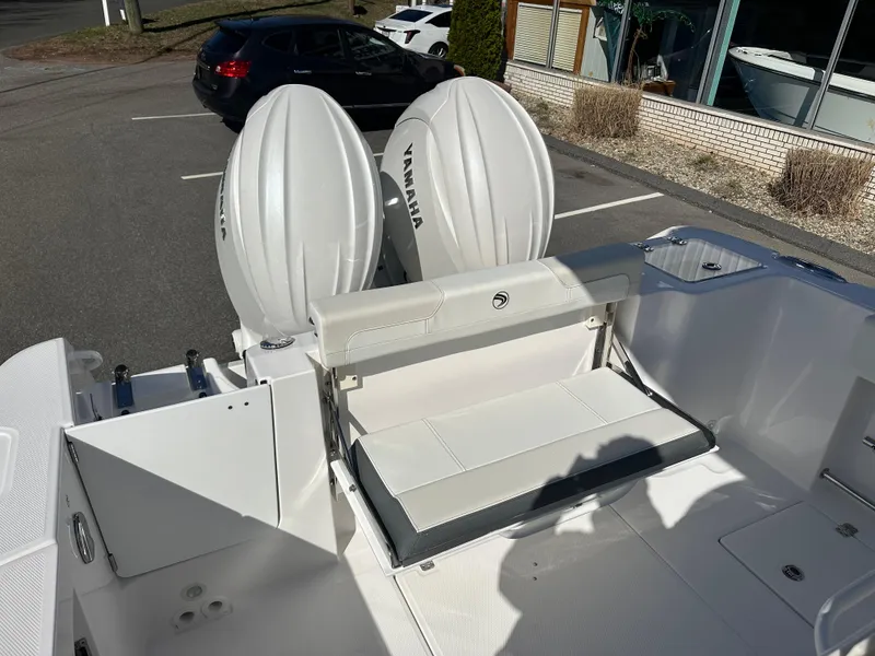 Slide: The Image of 2025 Edgewater 262 Center Console boat with dual Yamaha outboard engines in a parking lot. - 15