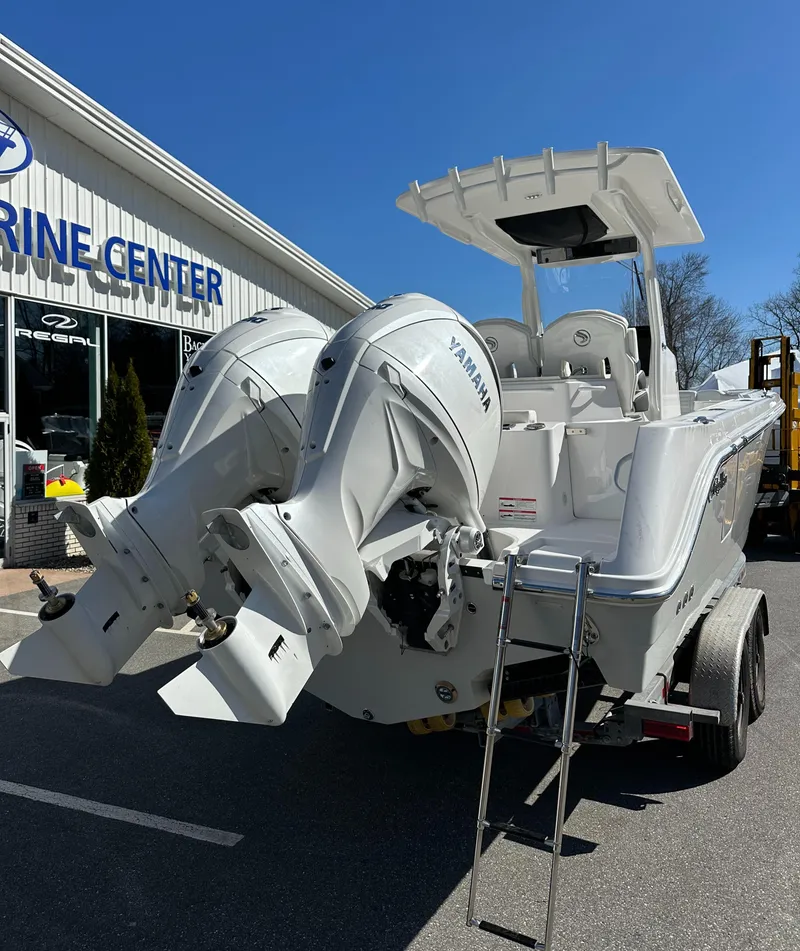Slide: The Image of 2025 Edgewater 262 Center Console boat with dual Yamaha engines at a marine center. - 8