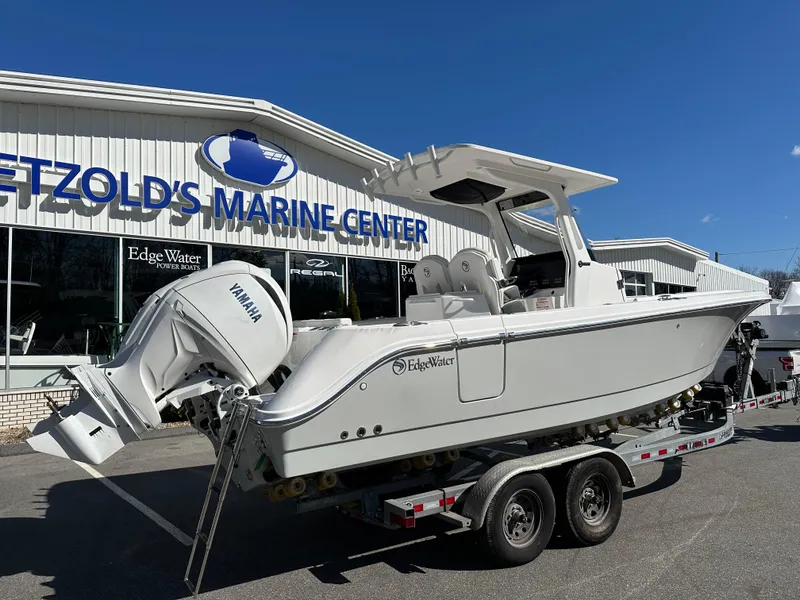 Slide: The Image of 2025 Edgewater 262 Center Console boat on trailer at marine center. - 9