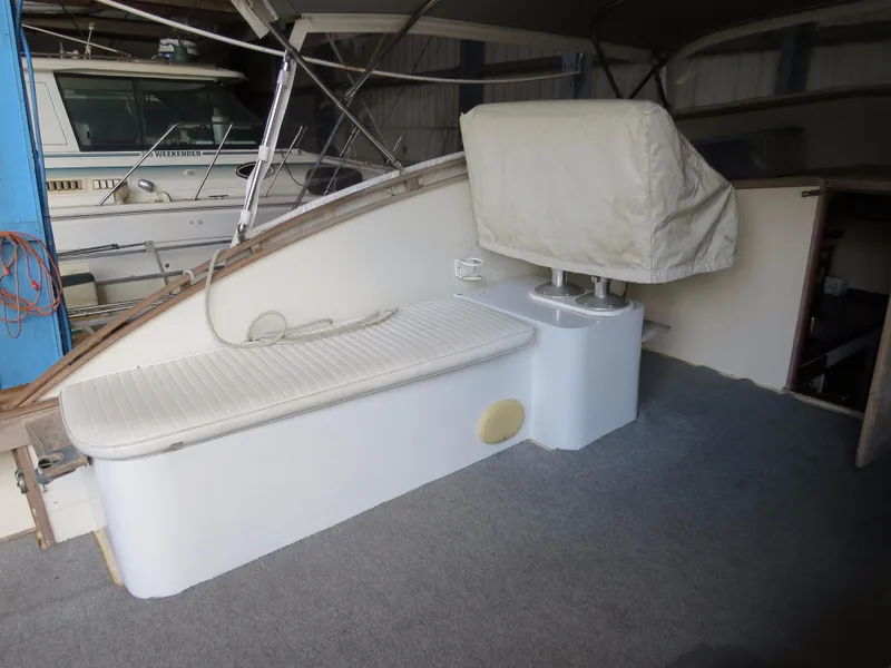 Slide: The Image of 1953 Rybovich Express boat interior with covered seating and carpeted floor. - 10