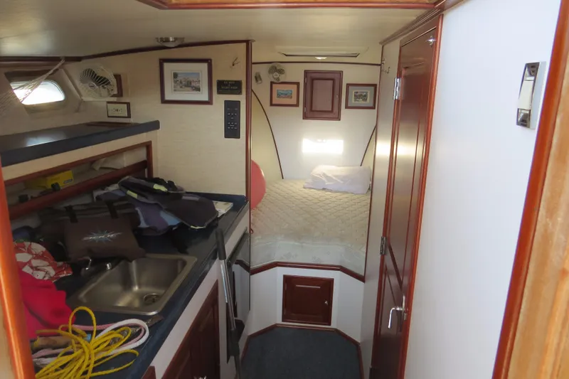 Slide: The Image of Interior of a 1953 Rybovich Express boat with a cozy cabin and kitchenette. - 14
