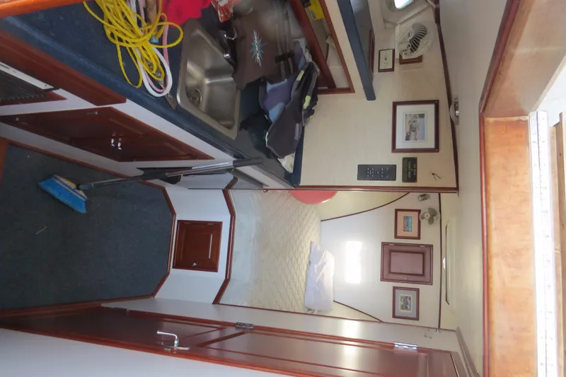 Slide: The Image of Interior of a 1953 Rybovich Express boat, featuring a compact kitchen and cozy cabin space. - 15