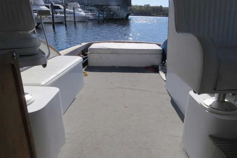 Slide: The Image of 1953 Rybovich Express boat interior with seating, overlooking marina and water. - 16