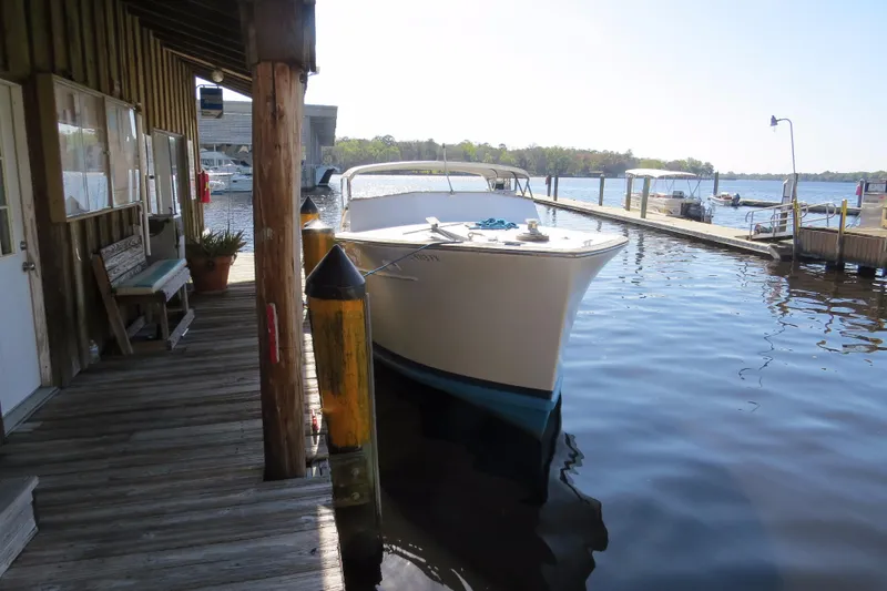 Slide: The Image of 1953 Rybovich Express boat docked at a wooden pier on a sunny day. - 17