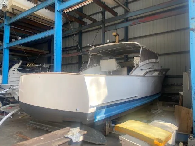 Slide: The Image of 1953 Rybovich Express boat in storage, showcasing classic design and craftsmanship. - 23