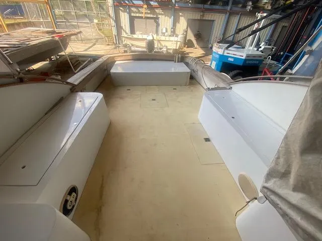 Slide: The Image of 1953 Rybovich Express boat interior with spacious deck and seating in a marina setting. - 27