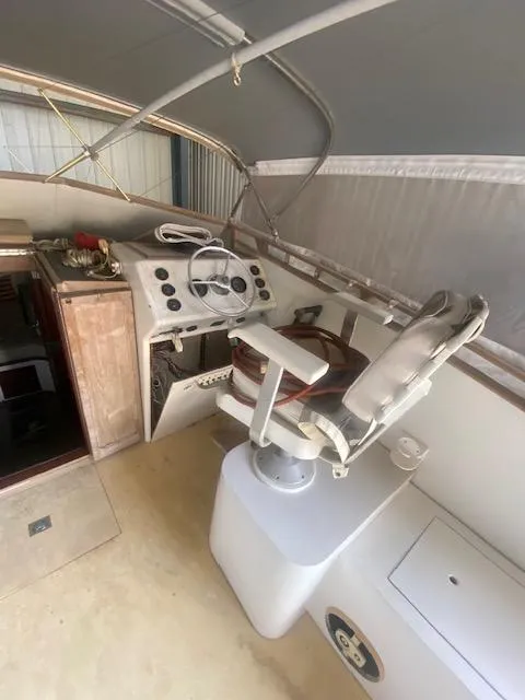 Slide: The Image of 1953 Rybovich Express boat interior with steering wheel and captain's chair. - 28